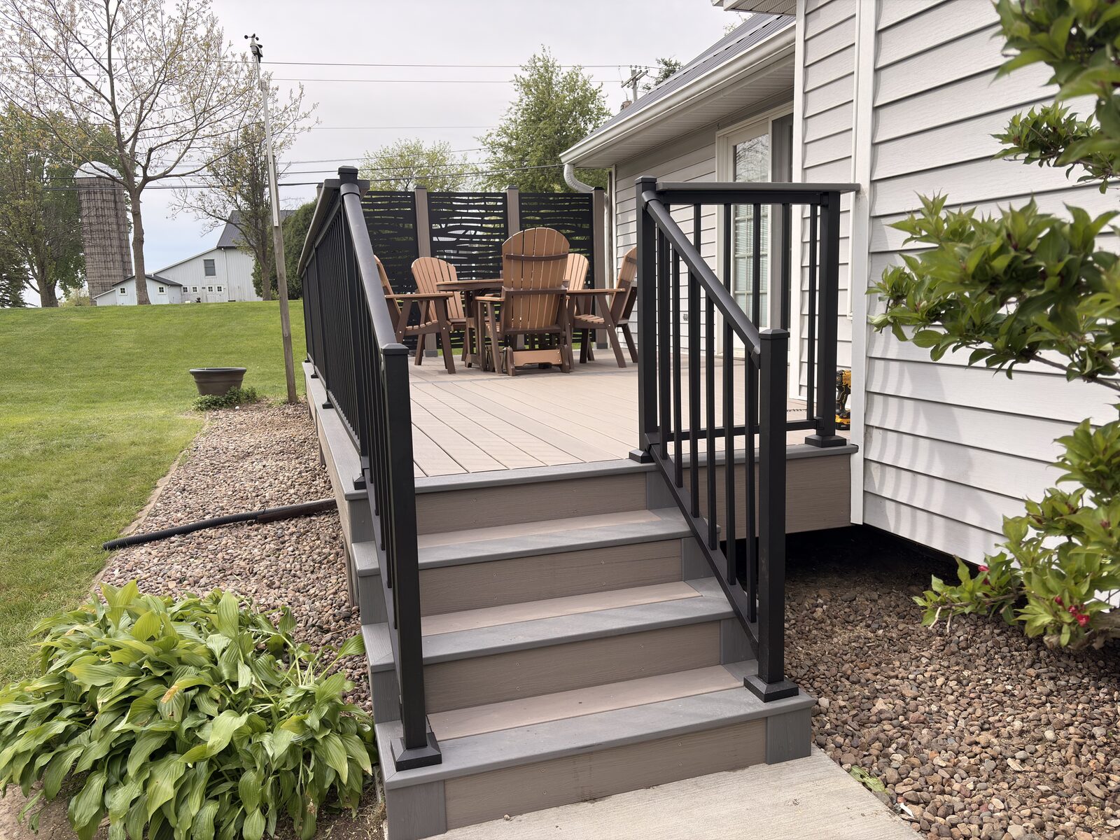 Custom composite deck with privacy screens built in Iowa City by T&T Home Improvement